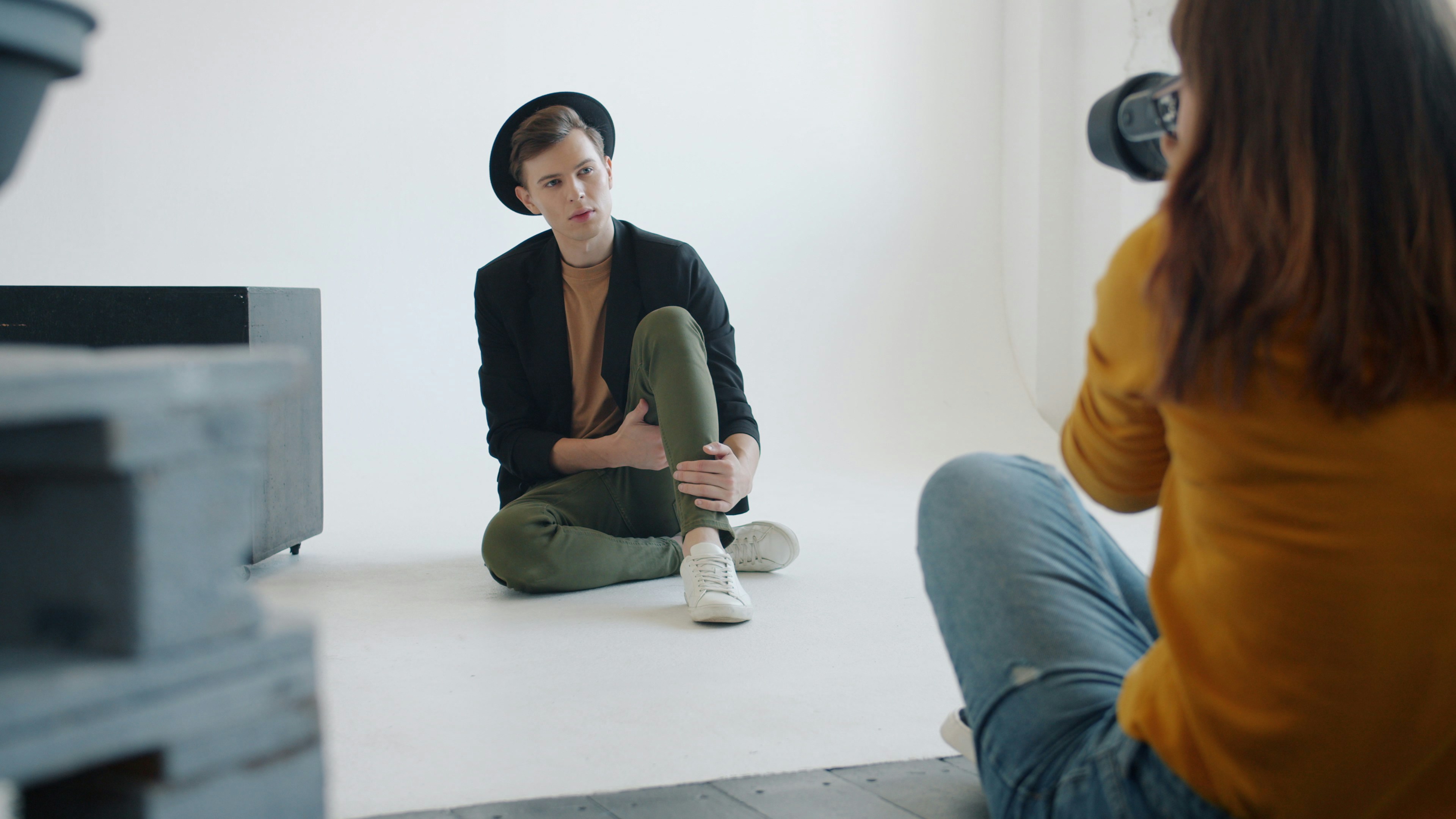 Photographer takes picture of model in studio.