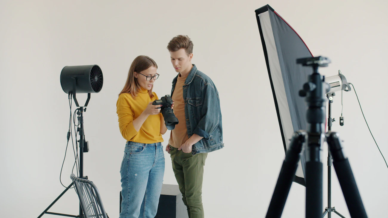 Photographer and model reviewing images in a studio