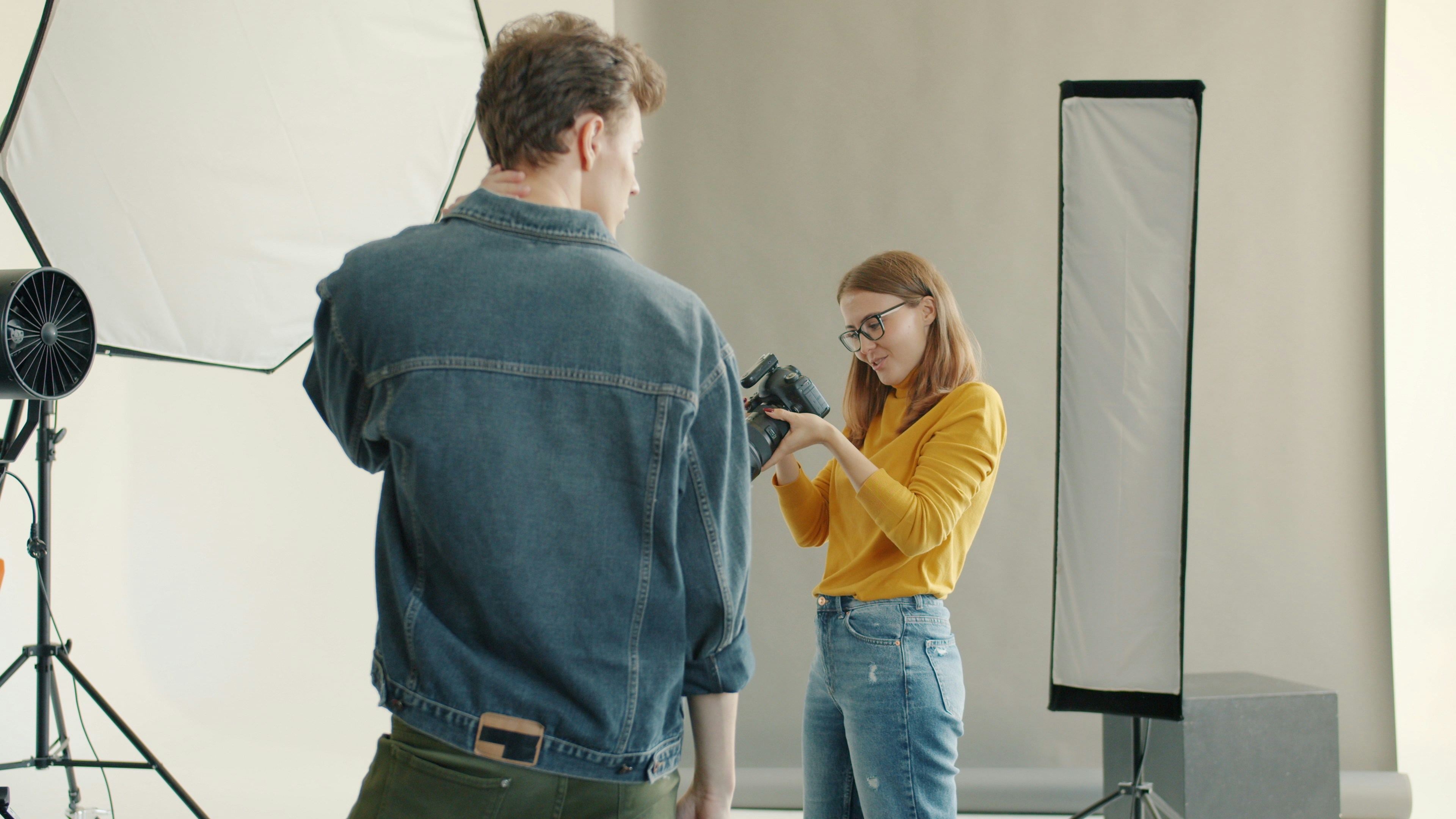Photographer directs model in a studio setting