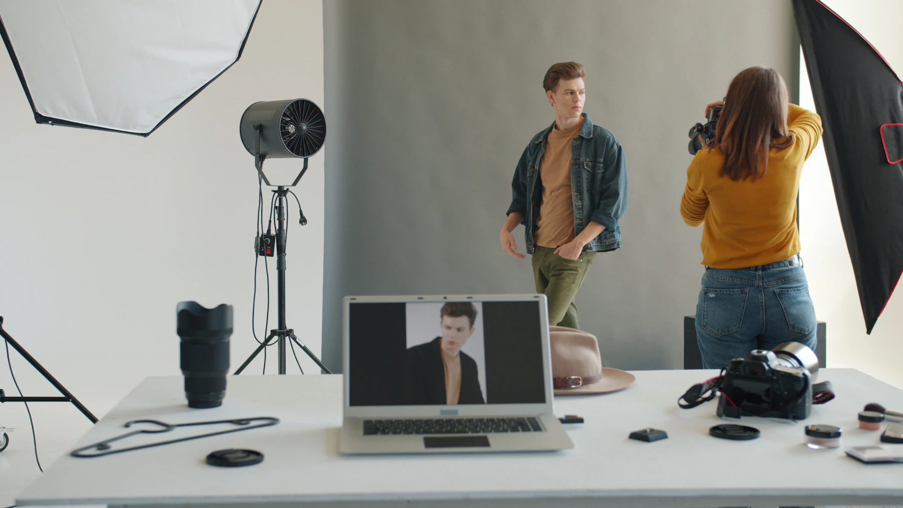 Photographer taking picture of male mannequin in studio
