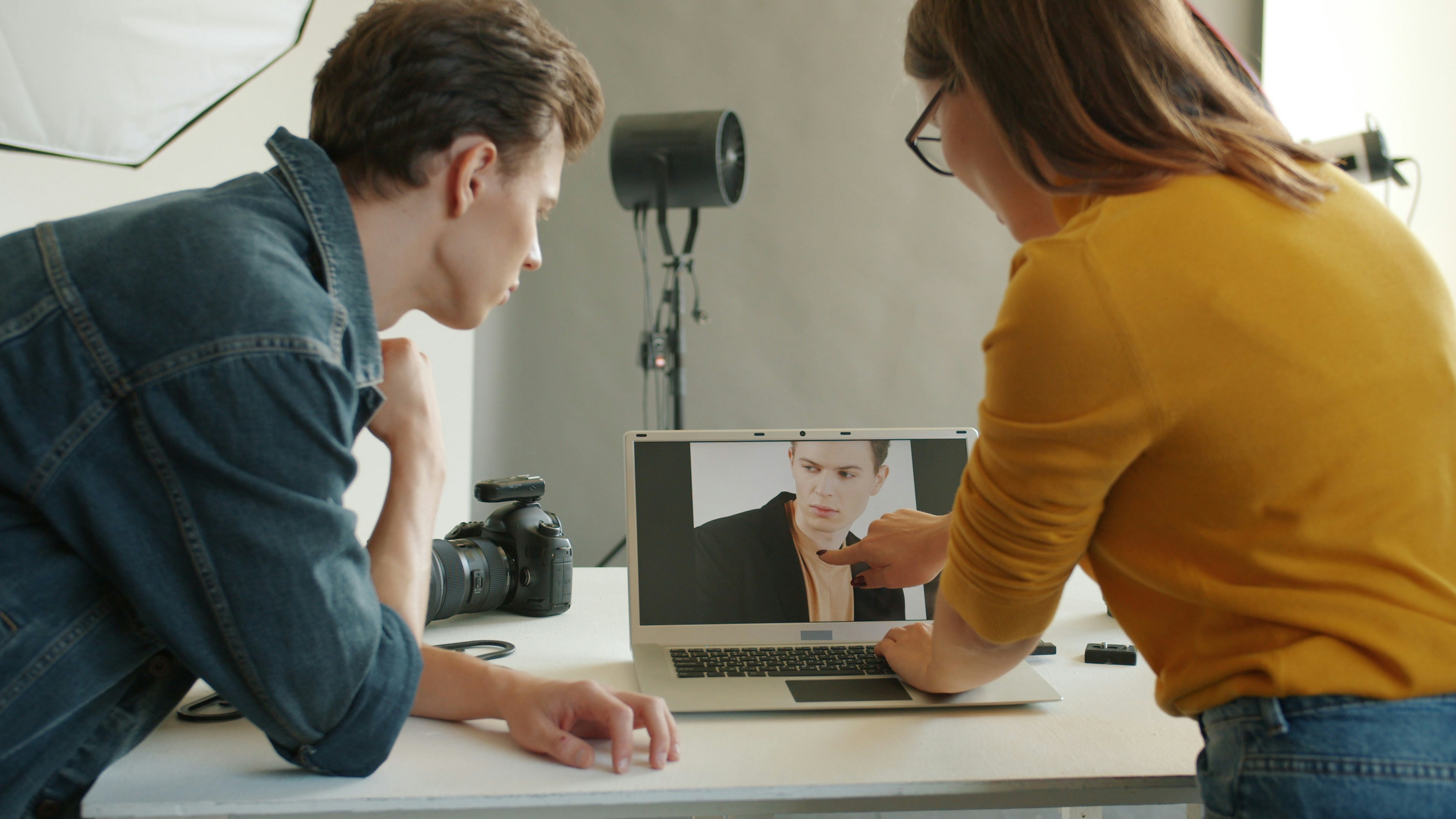 Two people looking at a laptop screen