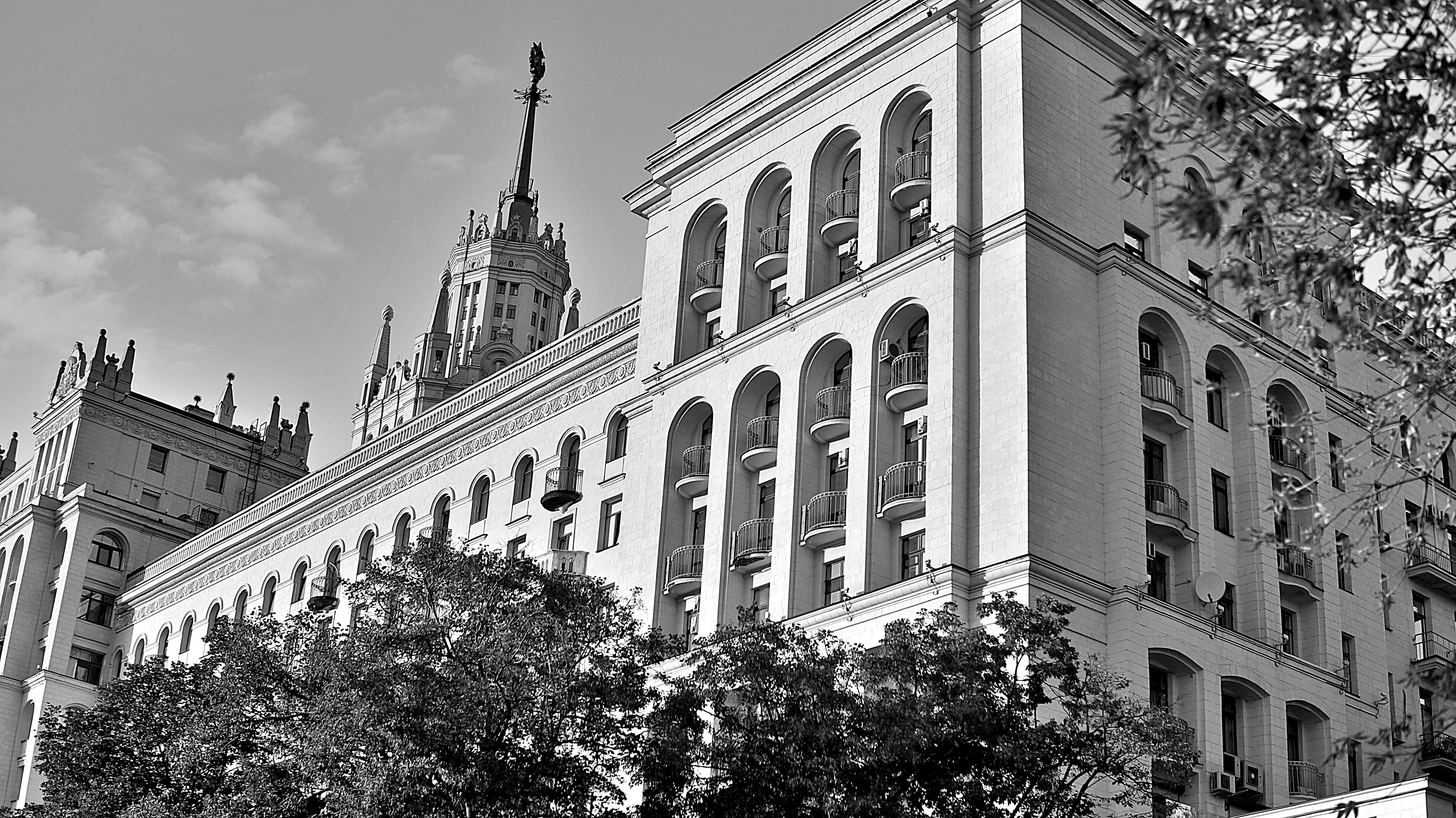 Ornate building with arched windows and spire.