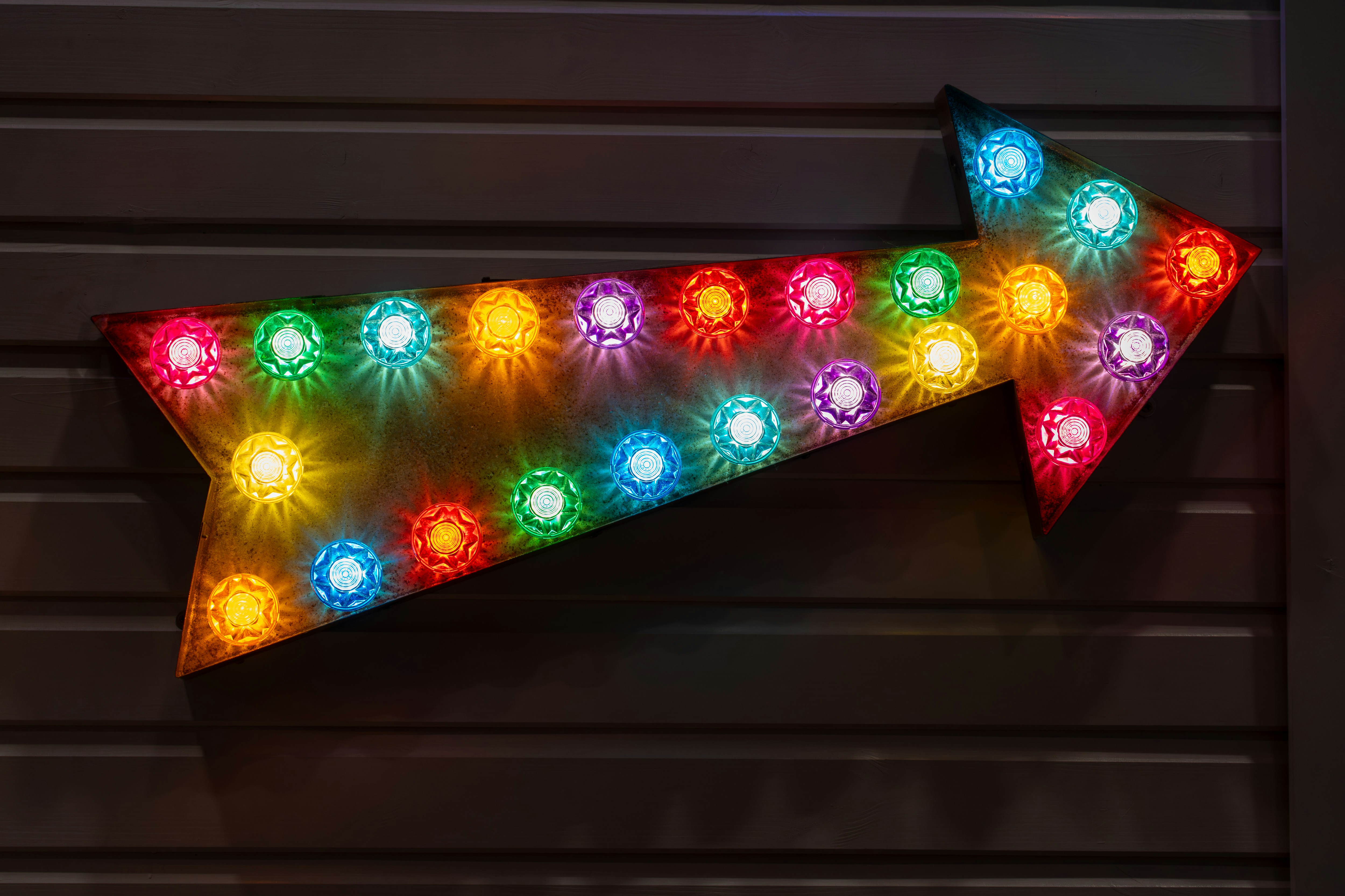 Arrow shaped sign with colorful glowing lights