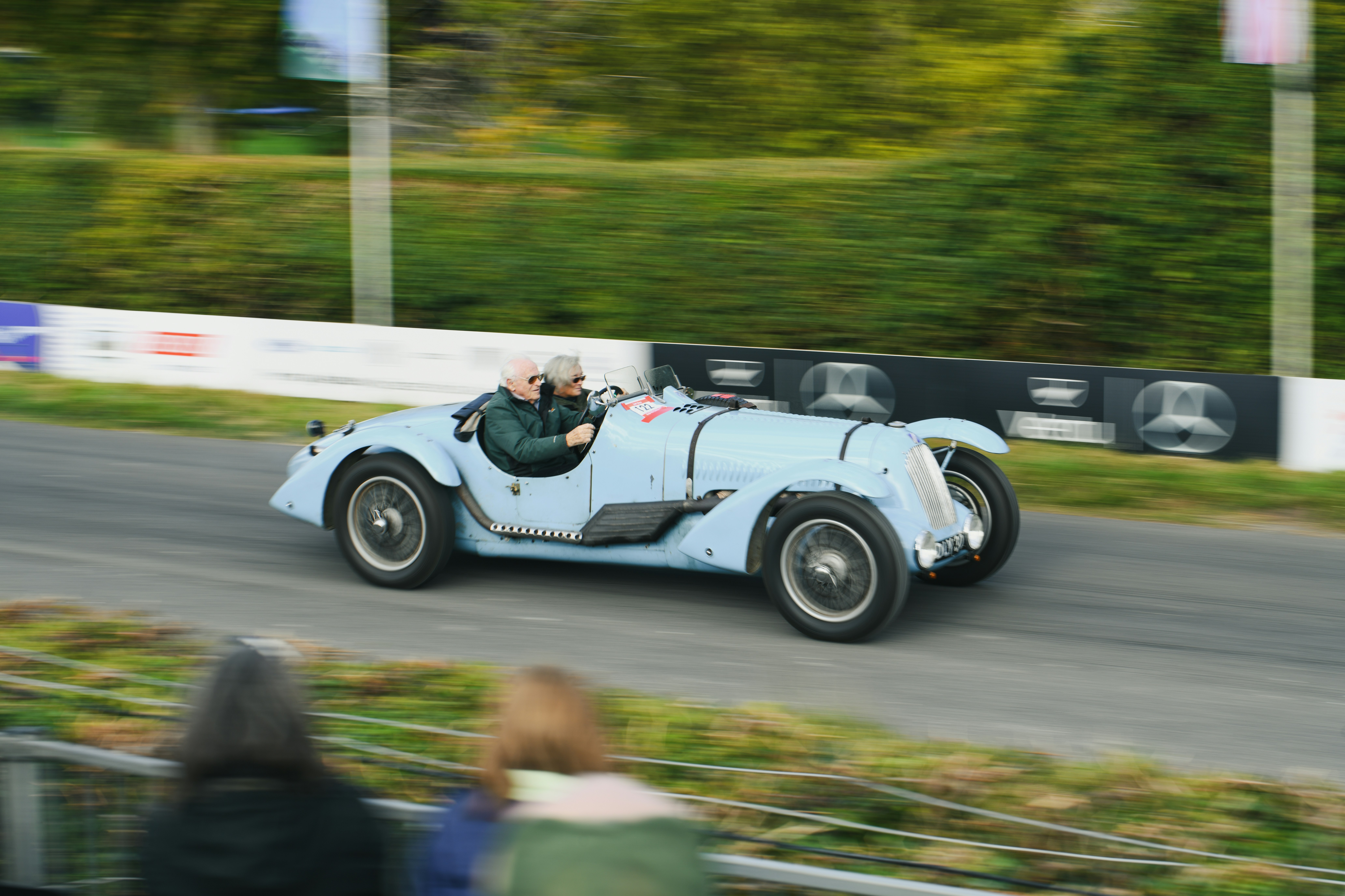 Vintage light blue car driving on a road