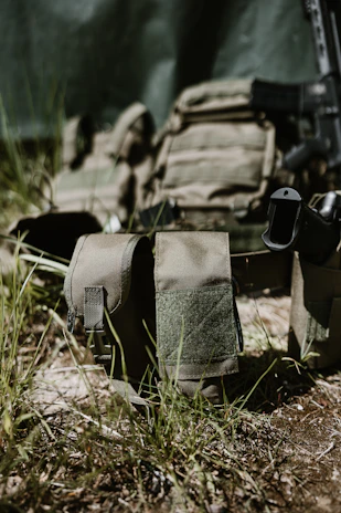 Tactical gear with rifle and magazine pouch.