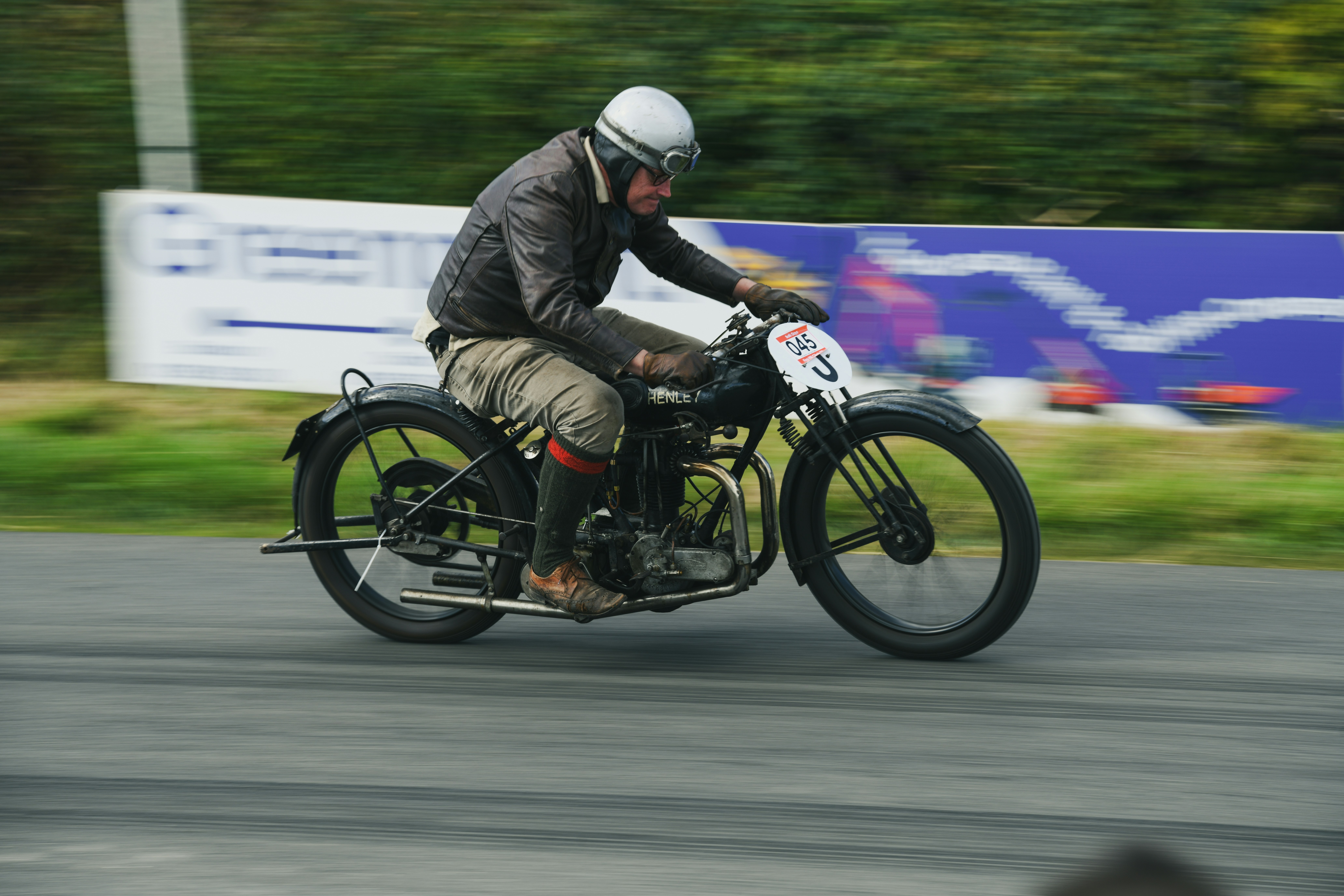 Man riding a vintage motorcycle on a track.