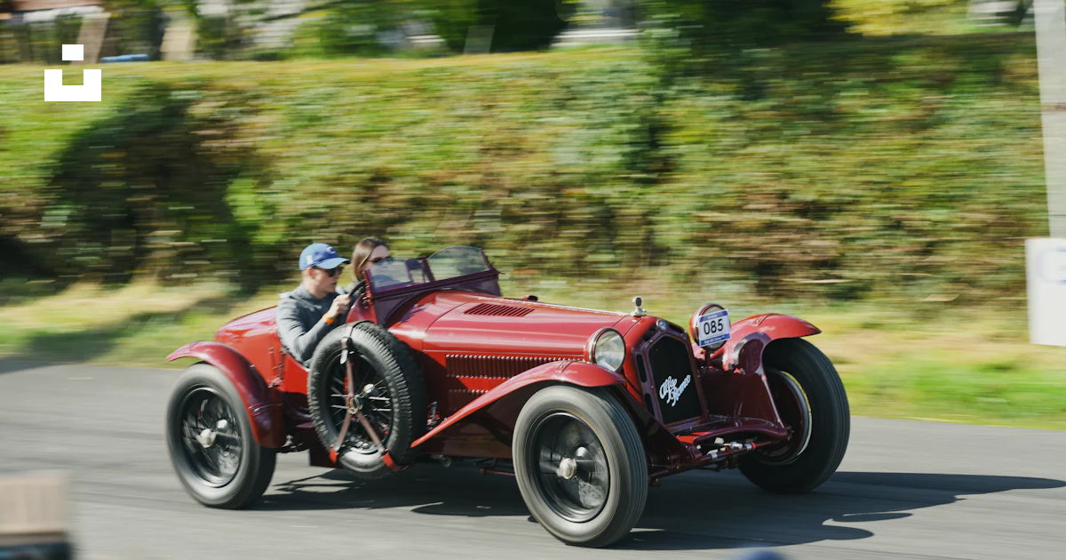 Vintage red convertible car racing on a road. photo – Free Sports car ...