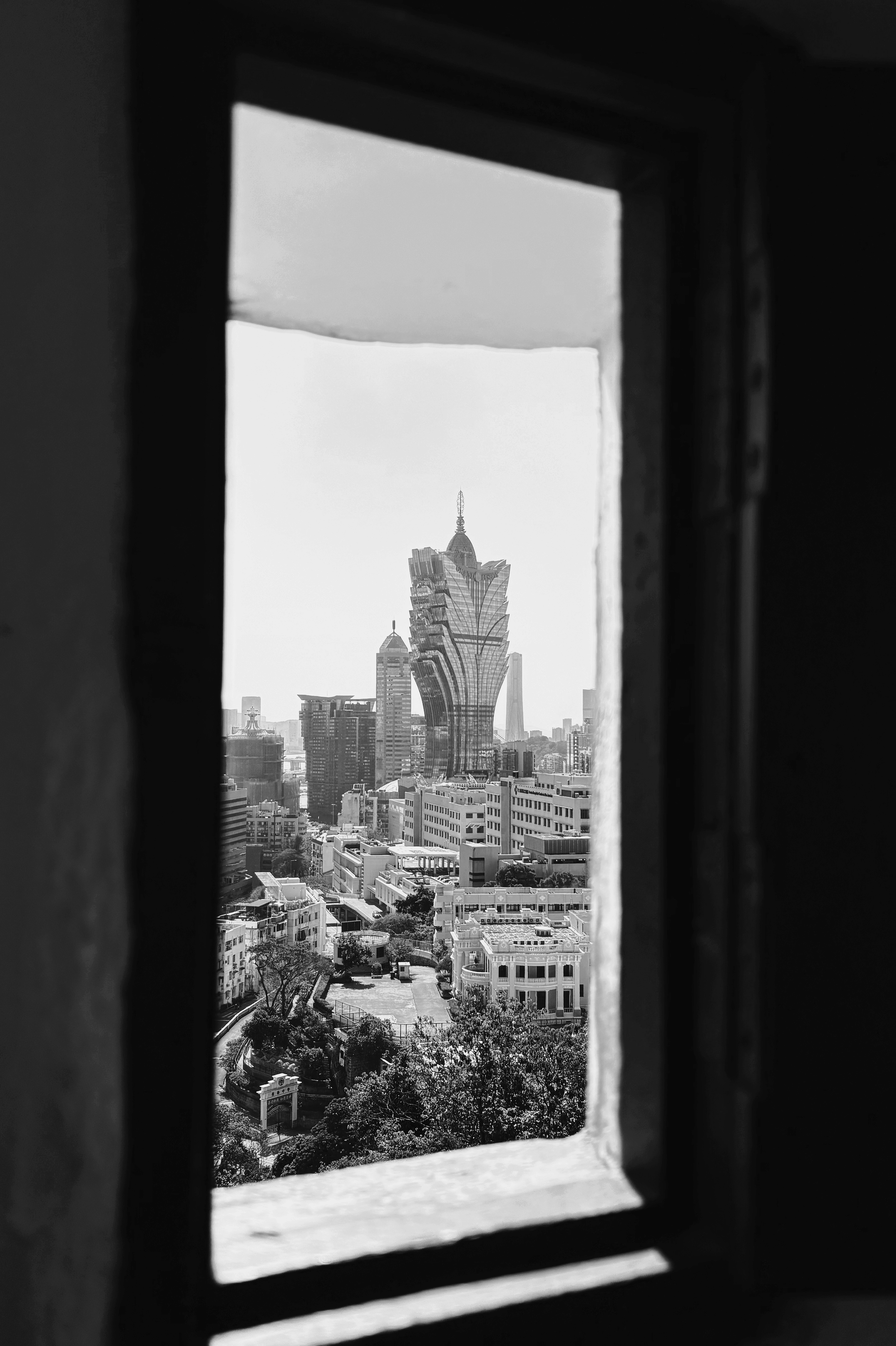 View of cityscape through an old window frame.