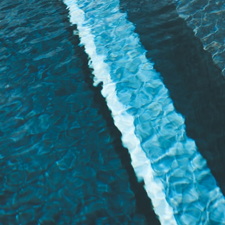 Rippling blue water with a white line.