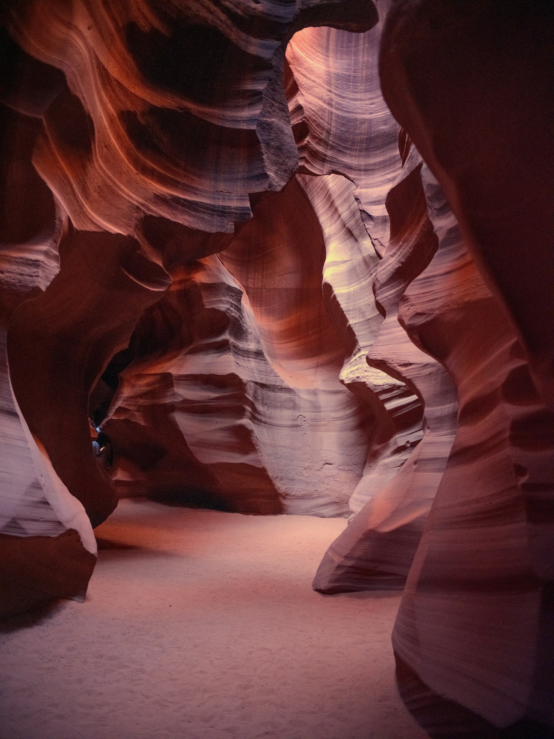 Winding sandstone canyon walls with dramatic light and shadow.