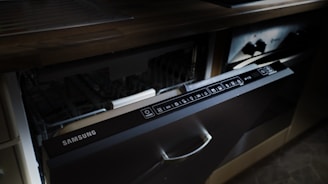 A modern samsung dishwasher drawer built into cabinetry.