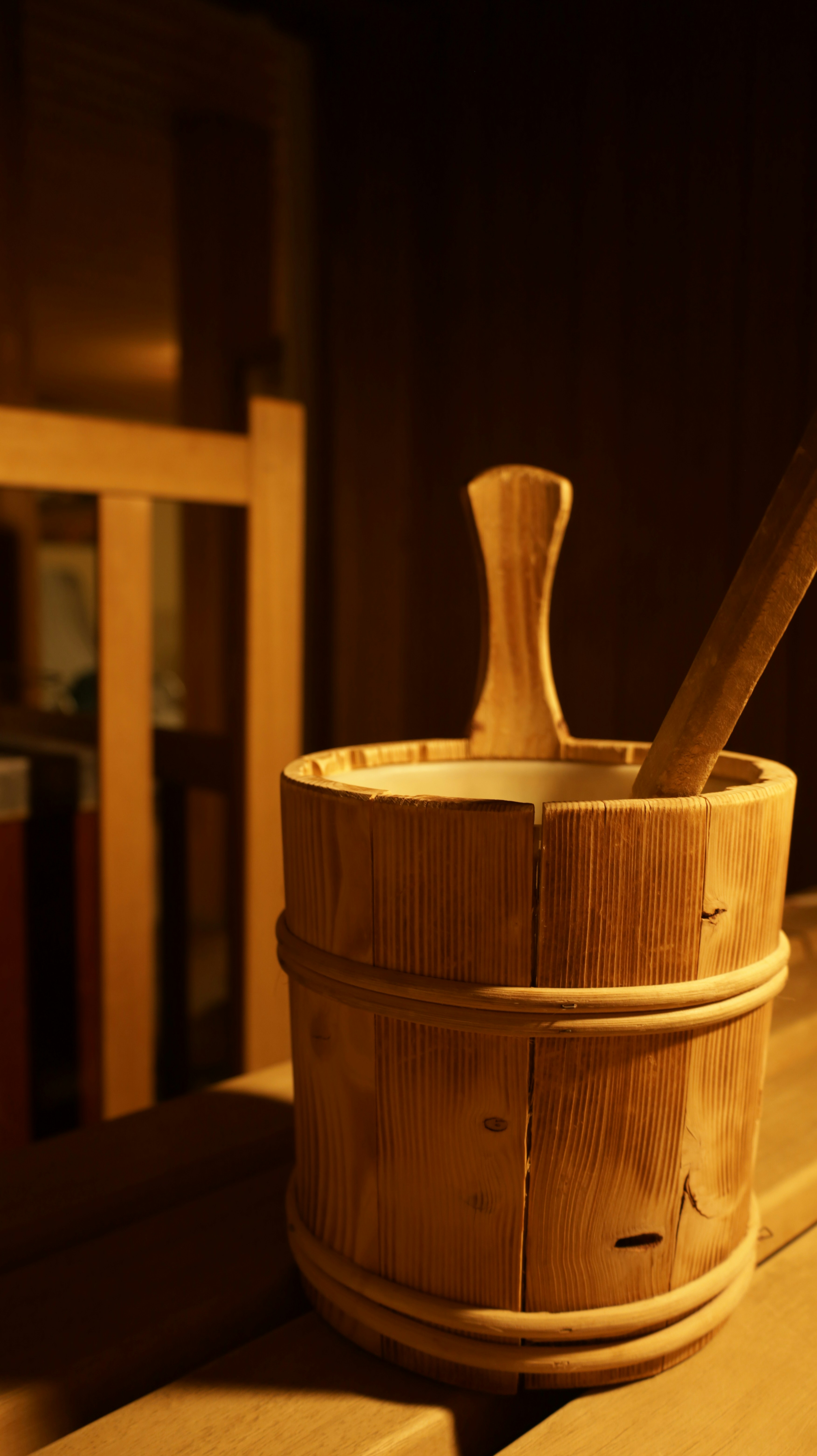 Wooden bucket with ladle in a sauna.
