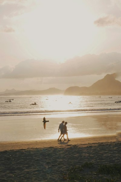 Cyprus free dating sites — couple walking along the coastline at sunset
