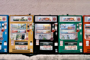 Row of colorful vending machines with tokyo signs