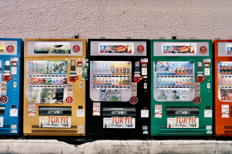 Row of colorful vending machines with tokyo signs