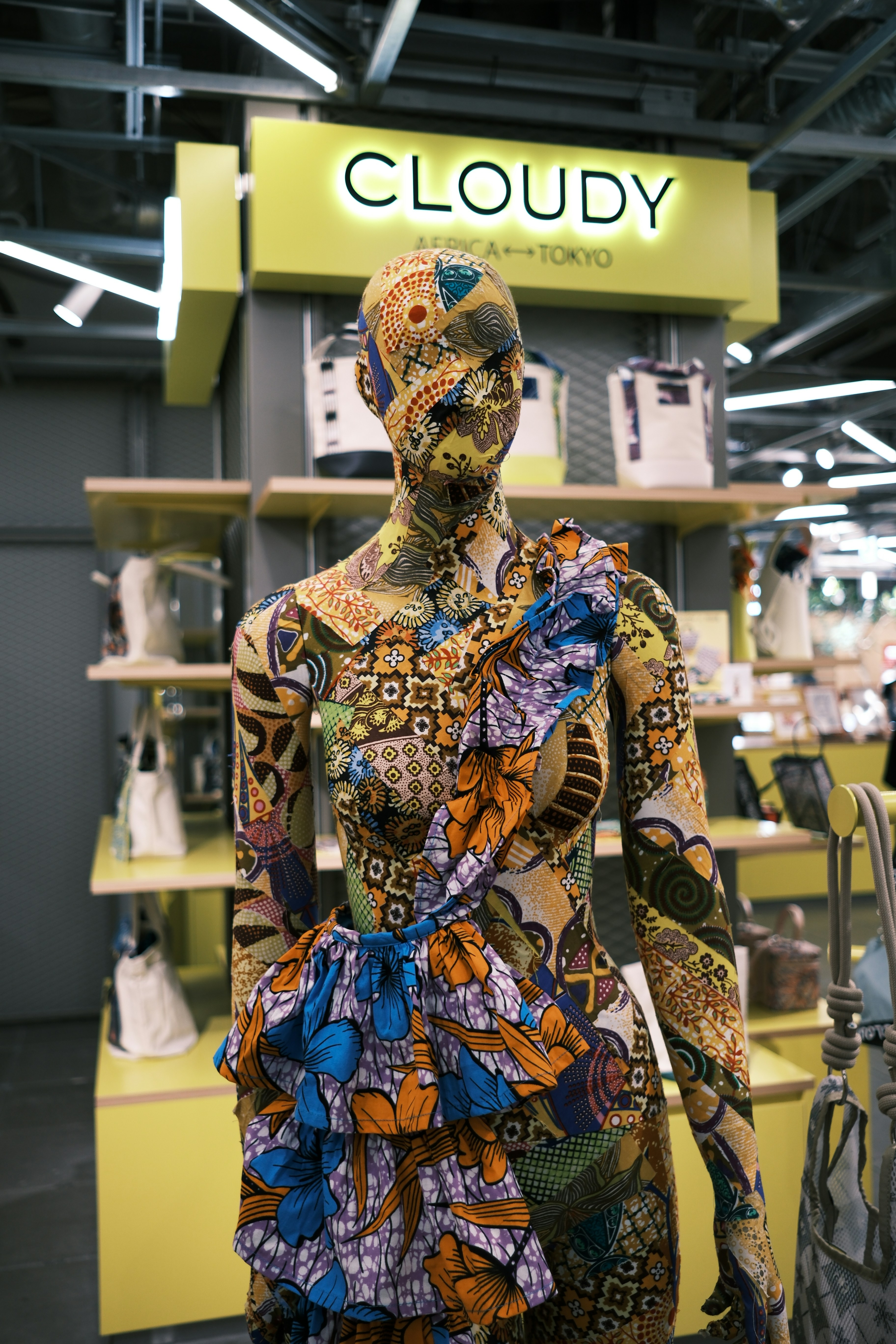 Mannequin covered in colorful patterned fabric.