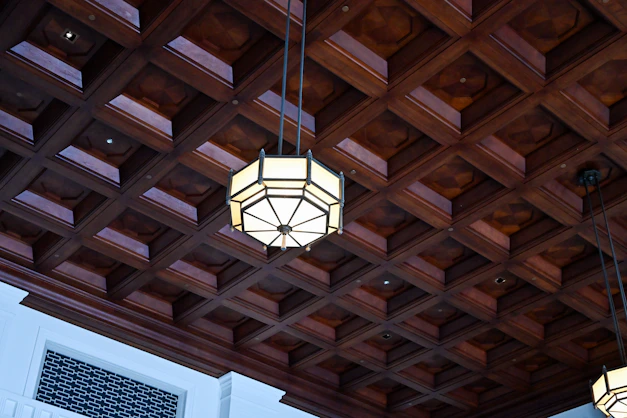 Ornate wooden coffered ceiling with geometric light fixture