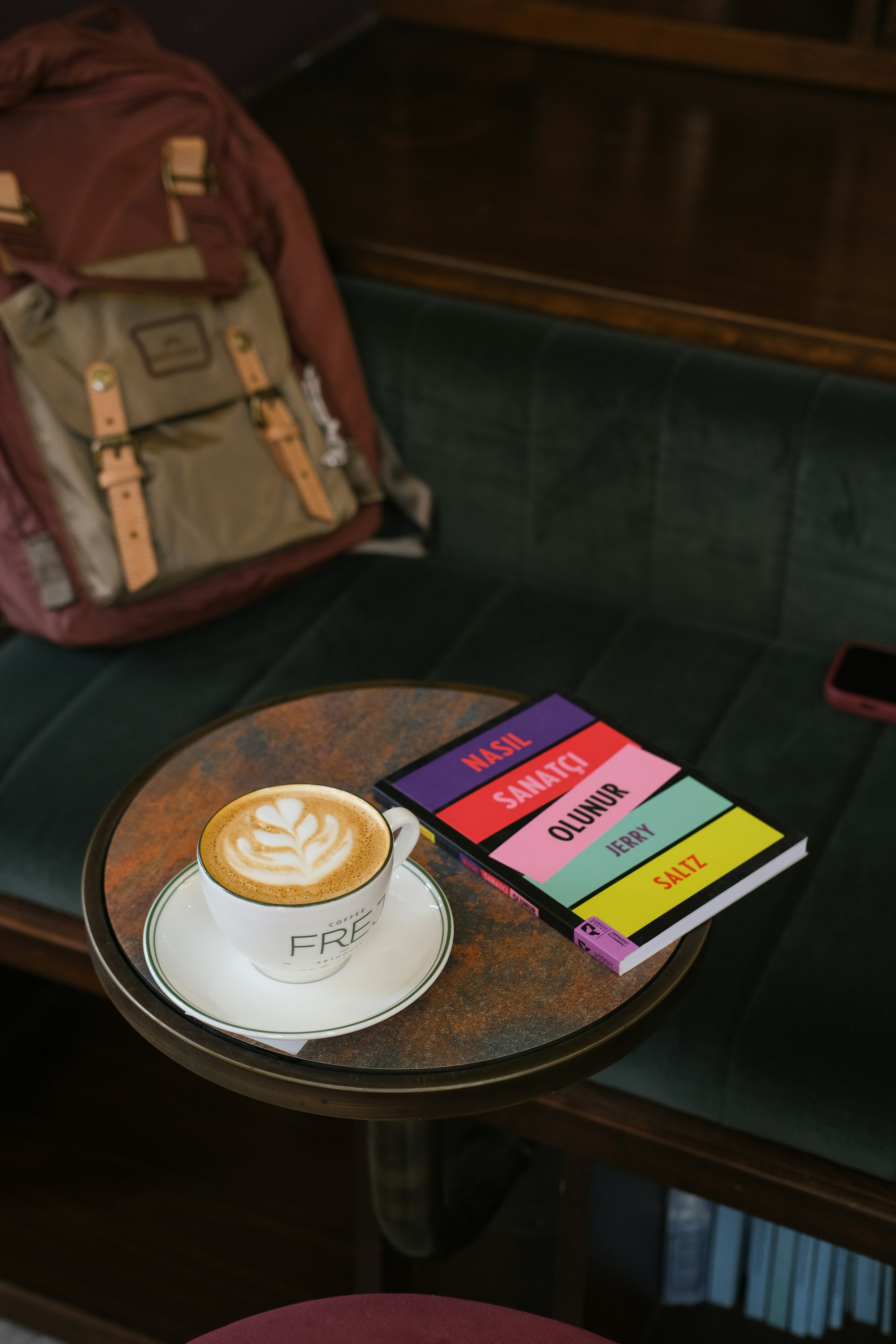 Latte art coffee and colorful notebook on table