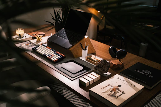 A modern desk setup with laptop and books.