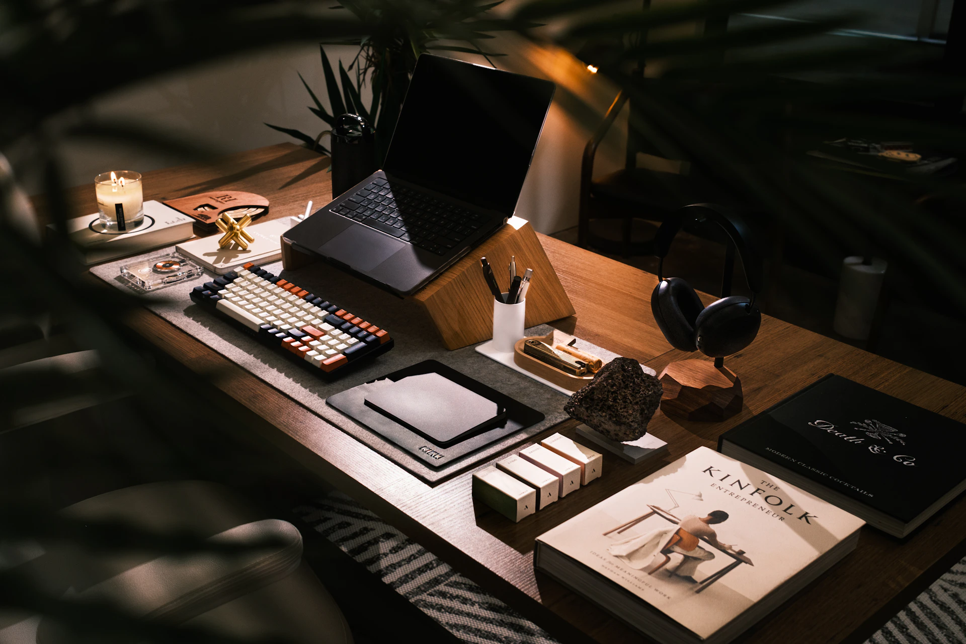 A modern desk setup with laptop and books.