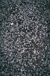 A textured background of small gray gravel stones.