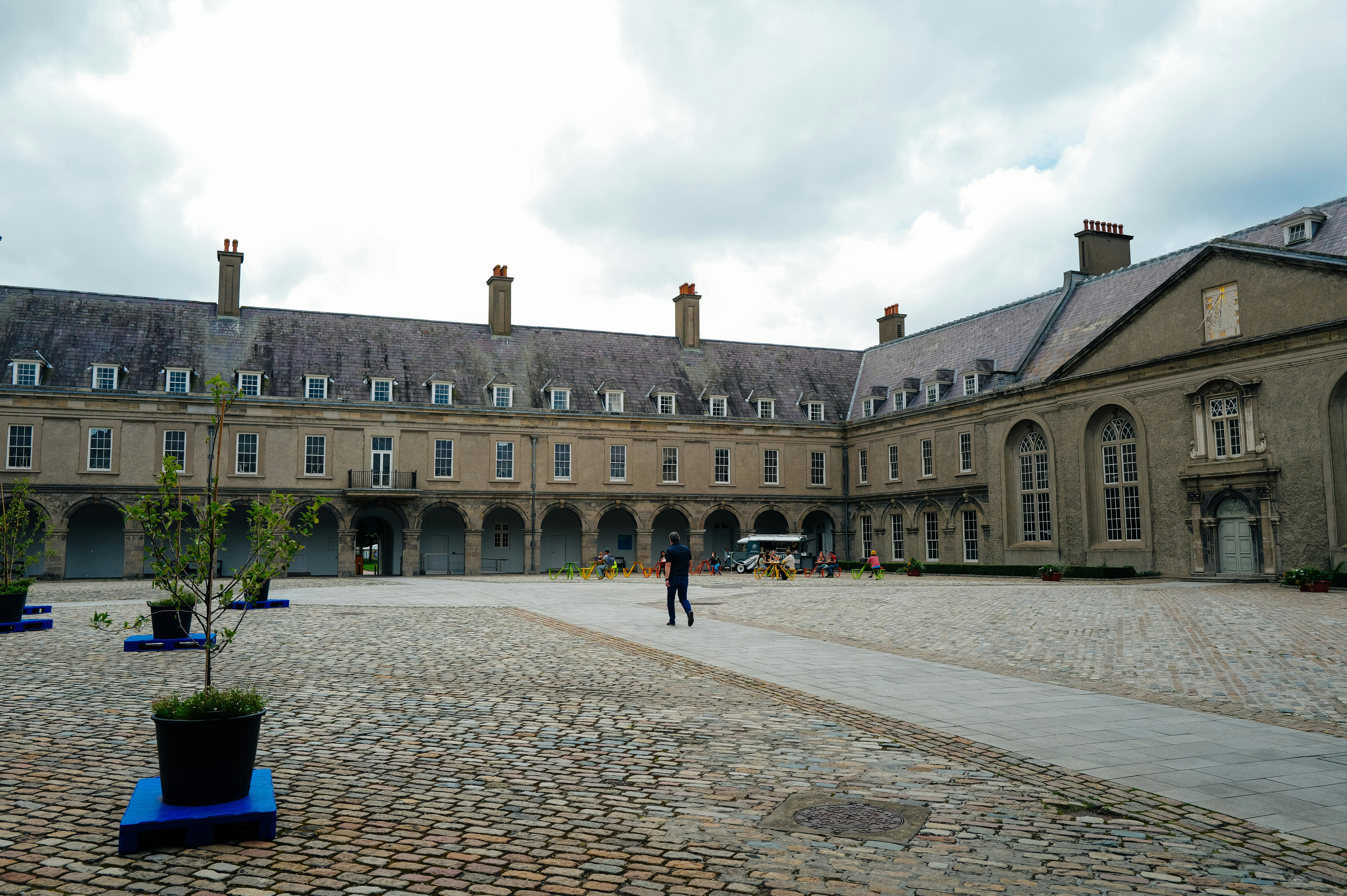 Courtyard of a large, historic stone building with arches.