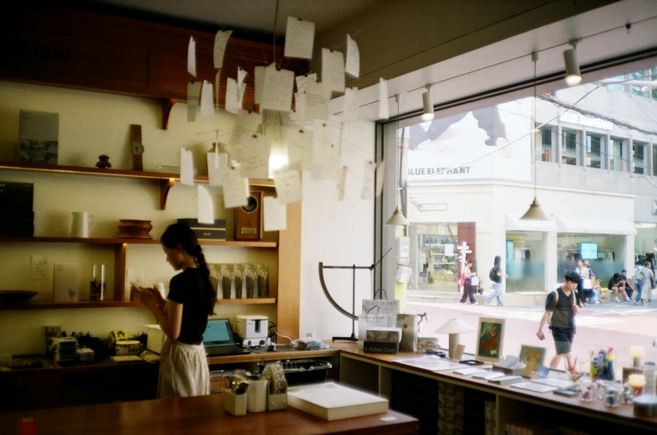 Woman browsing shelves in a store with street view