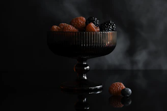 Dark glass bowl filled with fresh berries