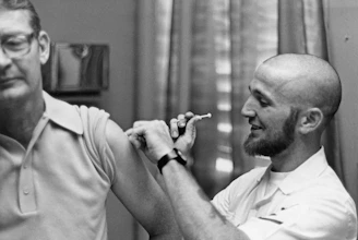 Doctor gives patient a vaccine shot