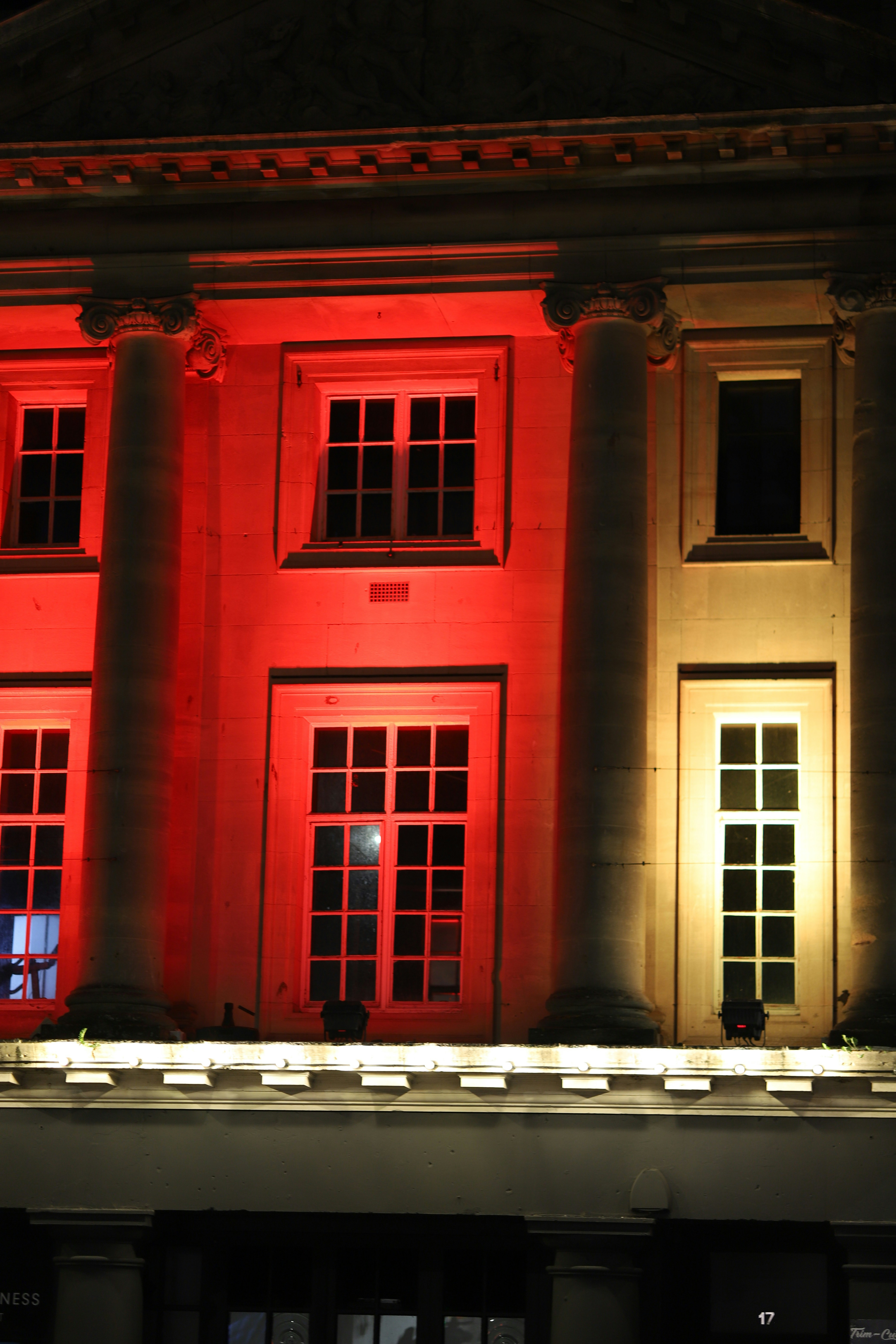 빨간색과 노란색 조명으로 밝혀진 건물 외관.