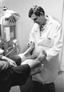 Doctor examining a patient's foot and ankle.