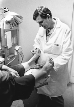 Doctor examining a patient's foot and ankle.