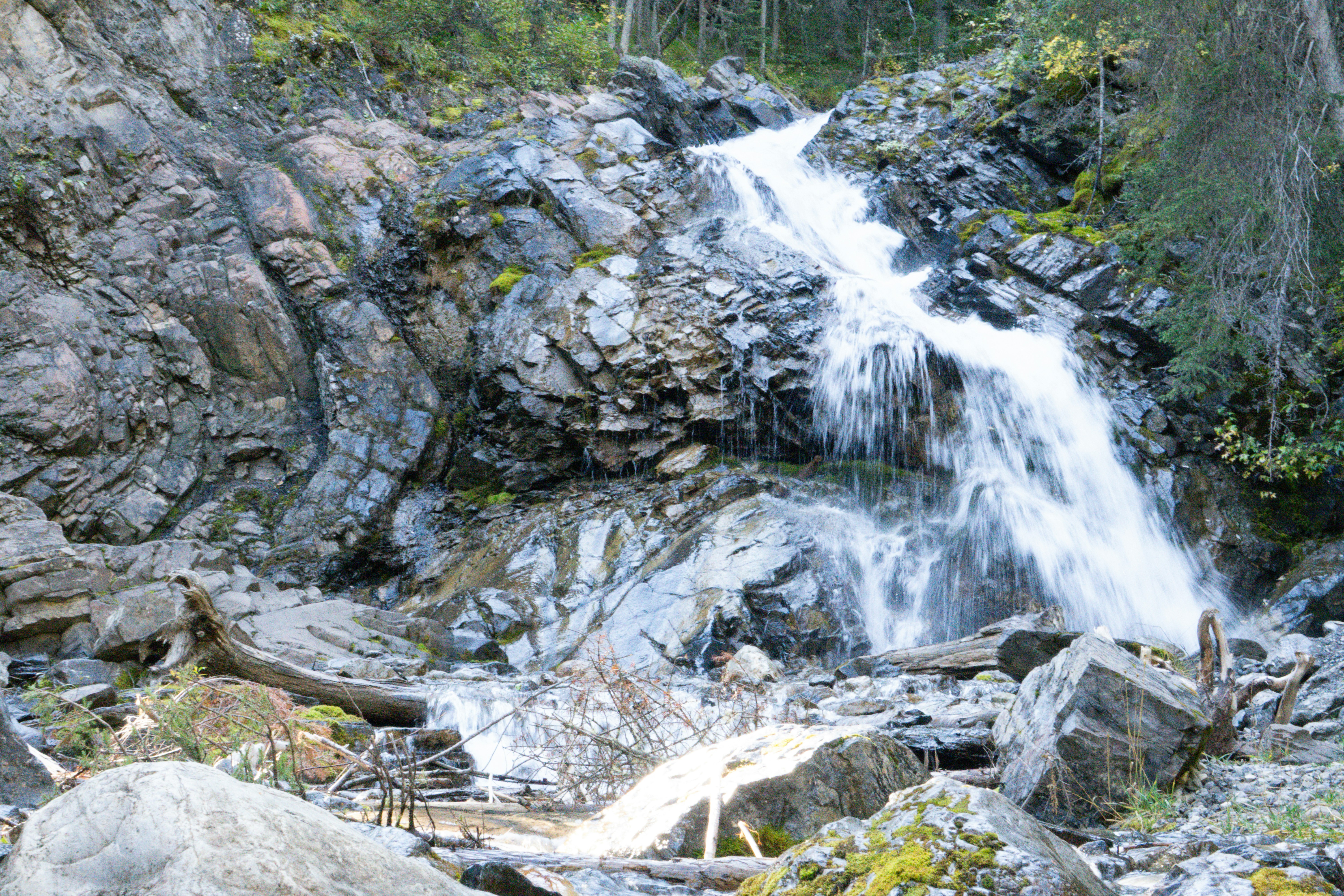 Waterfall cascades down rocky mountainside