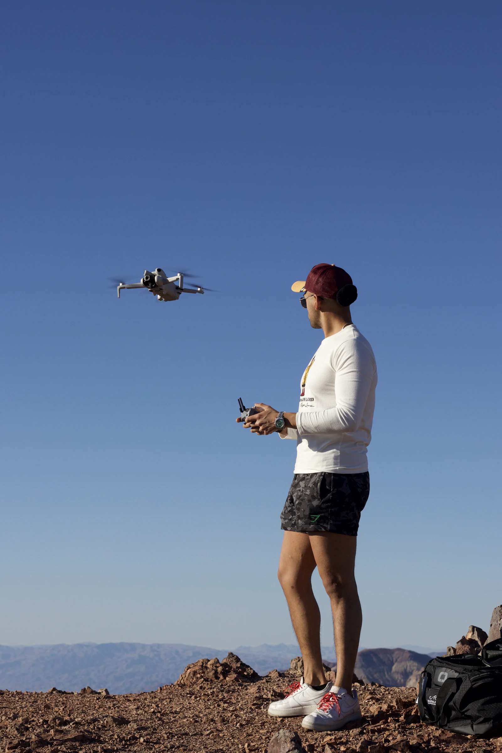 Camera-drone pilot photographing a mountain landscape