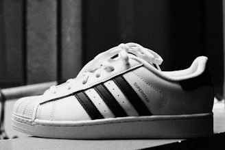 A black and white adidas superstar sneaker