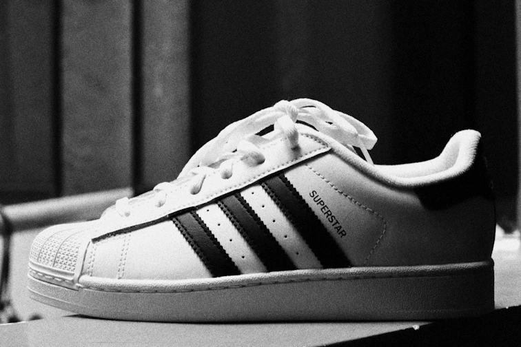 A black and white adidas superstar sneaker