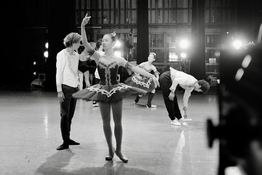Dancers rehearsing on a lit stage