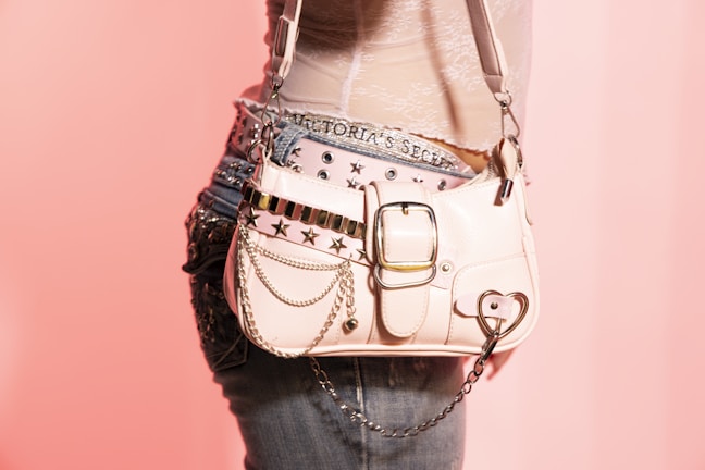 A pink purse with stars and chains