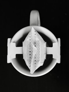 A single-serve coffee drip bag on a white mug.