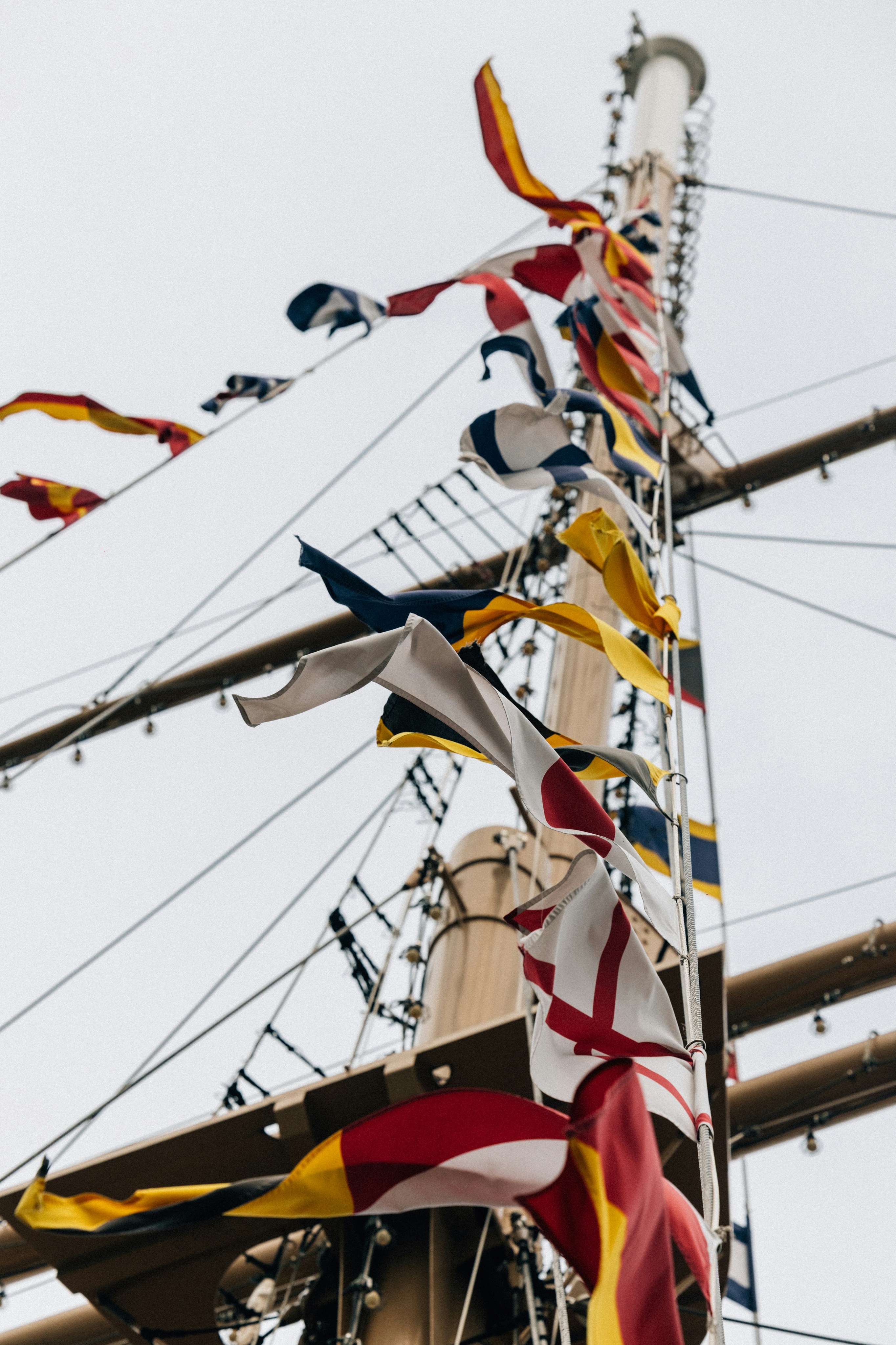 Nautical signal flags flying from a ship's mast