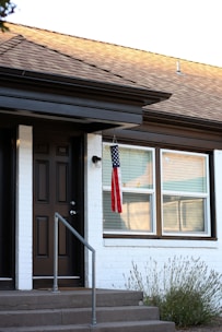 American flag hanging by a house entrance.