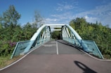 A pedestrian bridge over a paved path