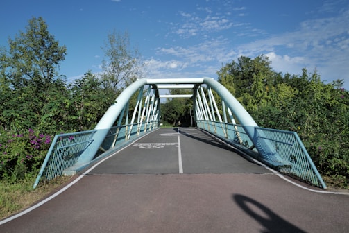 A pedestrian bridge over a paved path