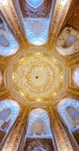 Ornate islamic architecture with intricate ceiling details.