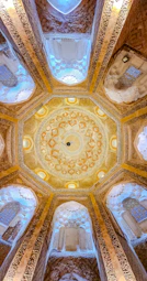 Ornate islamic architecture with intricate ceiling details.