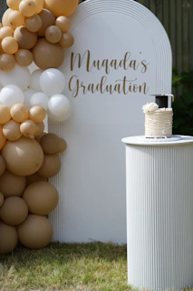Graduation celebration with balloons and cake.