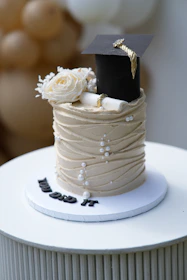 Graduation cake with cap, diploma, and flowers