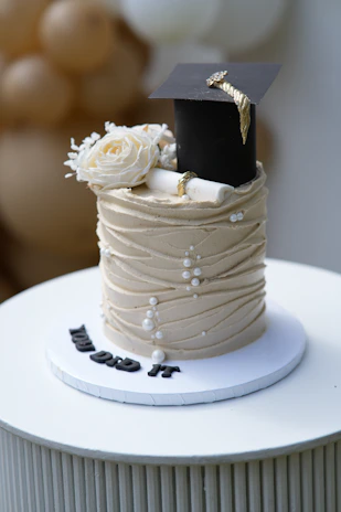 Graduation cake with cap, diploma, and flowers