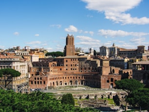 Ancient roman ruins and buildings under a blue sky.