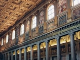 Ornate columns and paintings inside a grand hall